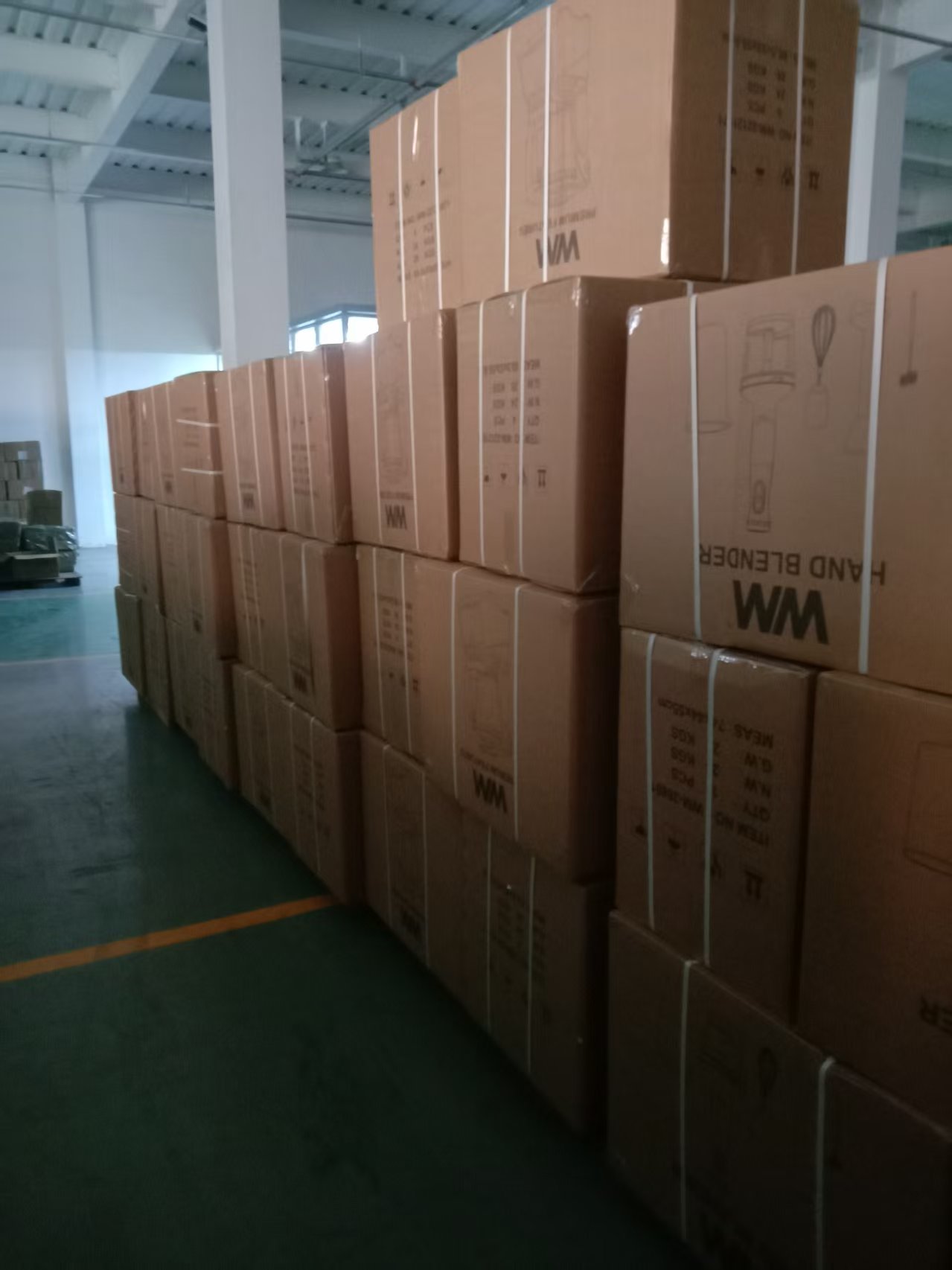 Stacked appliance cartons in an indoor carton staging area